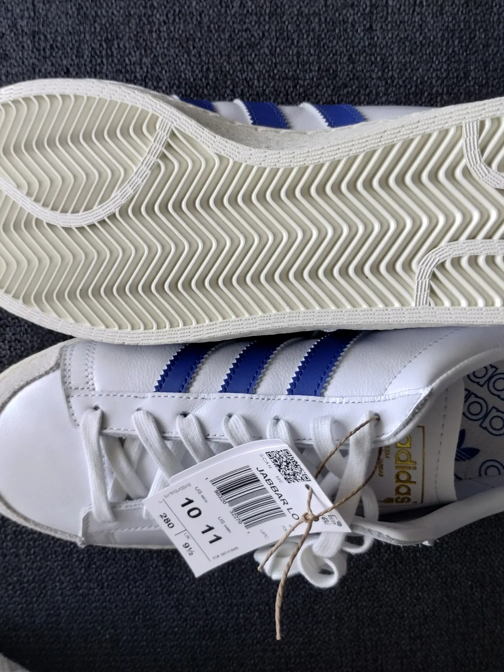 adidas White Sneakers with Blue Accents and Black Logo